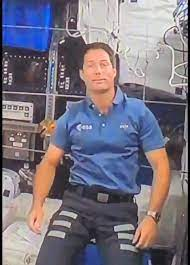 Harness wire over his left shoulder. If they are really in “outer space,” why all the trickery?