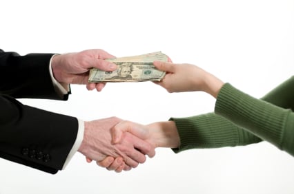two people exchanging money (a business transaction)