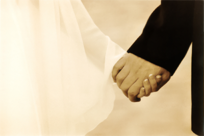 bride and groom holding hands