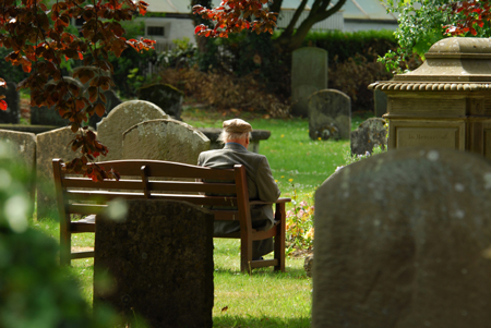 man sitting in cemetary