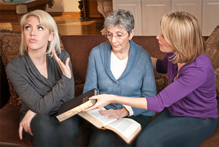 girl refusing to look at the Bible with her family