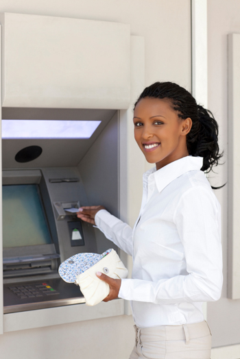 woman withdrawing money from atm machine