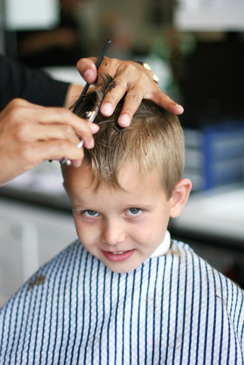 young boy getting his hair cut