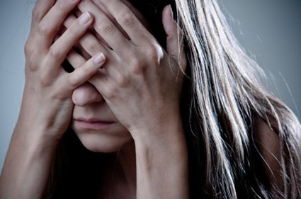 girl covering her face in despair