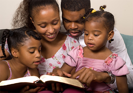 children studying the Bible with their parents