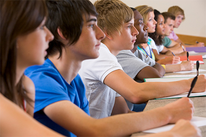 expressionless students sitting in a classroom