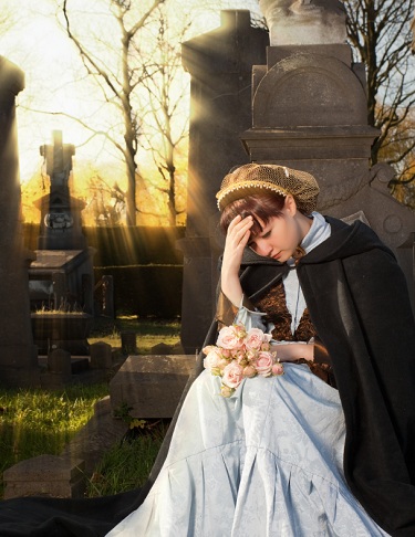 young woman grieving in cemetary