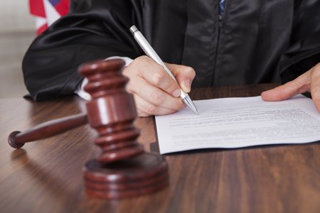 judge signing courtroom document