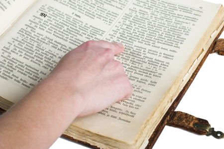 finger pointing to Bible text