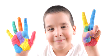 young boy holding up seven fingers
