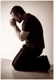 man kneeling in prayer