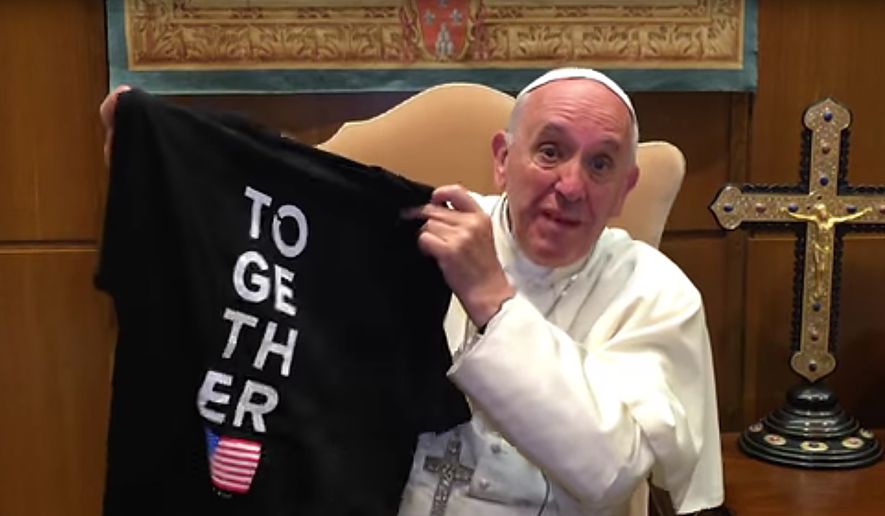 Pope Francis shows a Together 2016 t-shirt during his videoed invitation to youth.
