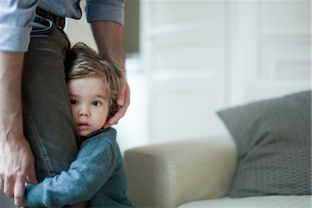 blygt barn som håller sig till förälder