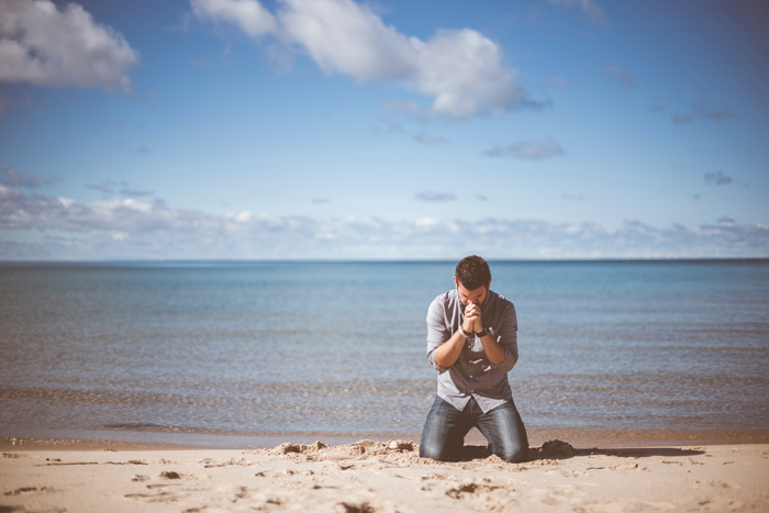 praying on the beach