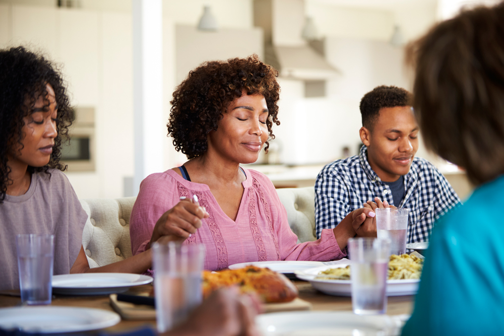 family praying before a meal