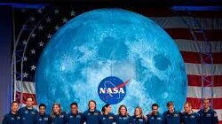 NASA claims to have landed on the moon once more, yet no pictures accompany the announcement. Instead, there are only people in a room, applauding, with a flat earth table at the center.