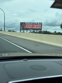 “Struggling to pay bills? Your taxes fund Israel.”  Seen in Orlando, USA.